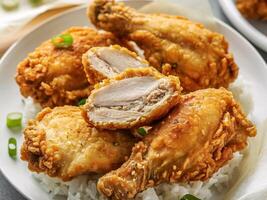Crispy fried chicken on a bed of fluffy rice photo