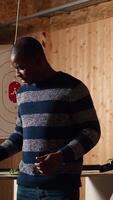Vertical Shooting gallery safety officer demonstrating how to safely reload pistol and gun to clients, supervising range activities. Firing range expert teaching proper weapon handling and usage, camera A video