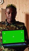Vertical Team of military units at shooting range watching on isolated screen laptop to learn necessary combat skills. Army soldiers looking at instructions on mockup notebook during training, camera A video