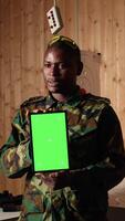 Vertical Team of military units at shooting range watching on green screen tablet to learn necessary combat skills. Army soldiers looking at instructions on chroma key device during training, camera A video