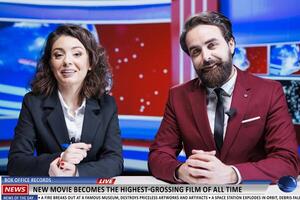 New movie television announcement in news studio, team of media journalists discuss about film breaking box office records and charts. Presenters work on live entertainment segment. photo
