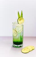 Panda leaves lemonade with desiccated coconut and green syrup on light gray background with copy space photo