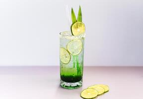 Panda leaves lemonade with desiccated coconut and green syrup on gray background with copy space photo