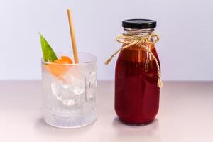 Healthy mixed juice made of carrot orange fruit, pink dragon fruit, apple with glass with ice photo
