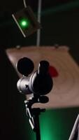 Vertical Shooting gallery client using rifle to hit targets, getting congratulated by instructor after great result. Woman doing thumbs up after receiving compliments for shooting bullseye, camera B video