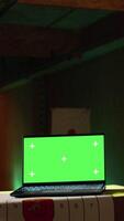 Vertical Chroma key notebook and shooting range customer reloading pistol, shooting targets. Isolated screen laptop next to man at shooting ground facility loading pistol, wearing protection goggles, camera A video