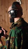 Vertical Man in firing range shooting targets with pistol doing face palm after missing. Disappointed person training with weapon feeling upset after failing to hit bullseyes, camera A video