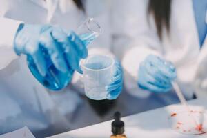 Two people in lab coats and gloves are working on a project photo