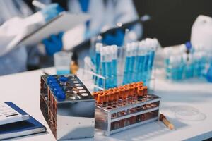 A laboratory table with several test tubes and other items photo