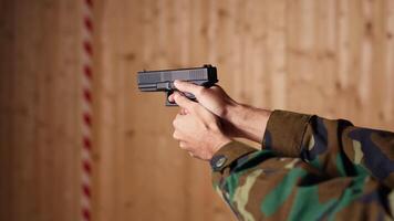 Man enjoying recreational shooting experience in firing range, checking if he shot bullseye. Person practicing with weapons in safe environment at shooting range company, hitting targets, camera B video