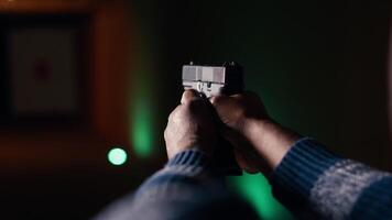 Firing range customer doing shooting activity with pistol, checking if he shot bullseye. Close up of person in shooting gallery learning how to use firearm, analyzing targets shot, camera B video