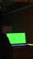 Vertical Green screen laptop in shooting range next to man successfully shooting targets. Mockup notebook next to person being congratulated by instructor for accurately hitting bullseye, camera A video