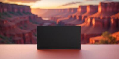 Black business card showing a colorful canyon illuminated by setting sun photo