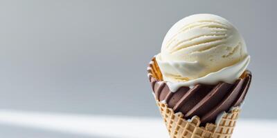 A scoop of ice cream in a chocolate and vanilla ice cream cone. photo