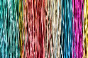 Many colorful prepared thread for weaving close up background photo