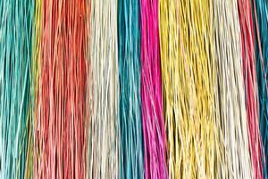 Many colorful prepared threads for weaving close up background photo