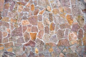 Stone wall with different pieces of tiles. Background photo