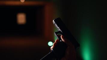 hombre recarga pistola en interior disparo rango, siguiendo la seguridad protocolos persona cuidadosamente manejo arma siguiendo metódico armas de fuego práctica la seguridad normas, cámara si cerca arriba video