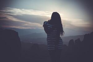 silhouette of a girl on sunset photo