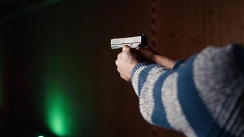 Firing range customer doing shooting activity with pistol, checking if he shot bullseye. Close up of person in shooting gallery learning how to use firearm, analyzing targets shot, camera A video