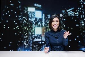 Presenter talking about latest events and covering all topics live on television program, presenting daily news in studio. Asian reporter hosting midnight talk show, global communications. photo