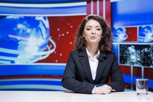Woman journalist reporting newscast in media studio, working as news anchor and reading important daily headlines. Presenter creating reportage with latest events for television content. photo