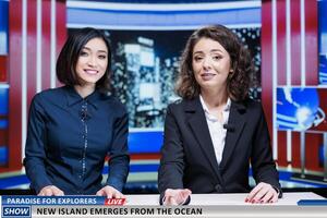 Media team talks about new island appearing on ocean coastline, creating paradise region for explorers and scientists. Women working as newscasters on night show presenting latest events. photo