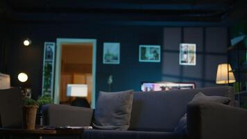 Cozy high end apartment illuminated with neon lights and a big tv, home theatre and setup for a young adult. Empty loft decorated and equipped with electronics, comfortable space. video