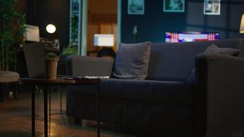 Contemporary apartment with modern indoor plants and neon lights creating a cozy casual living room with a smart tv and comfortable setup. Empty studio loft with trendy furniture. video