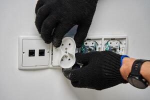 Electrician installing power socket photo