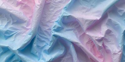 Crumpled blue and pink textured background with a gradient effect offers depth and visual intrigue for creative designs and compositions. photo