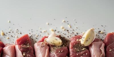 A pile of meat with garlic and pepper on top. photo