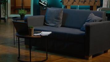 Stylish empty apartment loft with a comfortable couch and smart tv in the living room, modern space with decorations and funky neon lights. Studio with a coffee table and home theatre setup. video