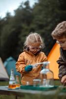 Kids engage in hands-on experiments at a well-equipped science station in a lush outdoor setting, surrounded by tents and greenery. They use quality tools to learn and discover photo