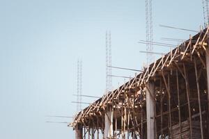 Construction site, Metal scaffolding and formwork, Residential buildings Construction, Beam formwork support system of newly built building at construction site on blue sky background with copy space photo