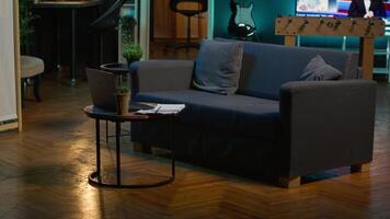 Stylish modern apartment decorated with cool furniture and neon lights, home theatre and setup with big tv for a young adult. Empty loft illuminated and equipped with electronics, comfortable space. video
