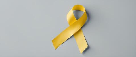 Global Autism Awareness Yellow Ribbon on Gray Background with Space for Text or Messages Promoting Awareness and Support for Autism Spectrum Disorder. photo