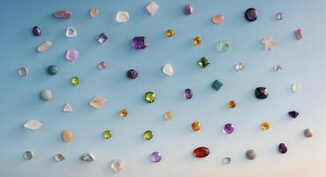 Top view of assorted healing gemstones on a clear sky background with space for text showcasing astrology and zodiac sign connections photo