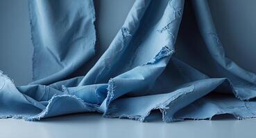 Tattered blue fabric texture with visible fringes and tears. photo