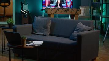 Cozy modern apartment decorated with neon lights and a big tv, home theatre and setup for a young adult. Empty loft studio illuminated and equipped with electronics, comfortable space. video