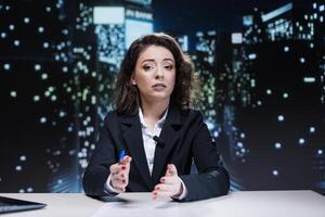 Journalist discussing about latest news, creating newscast reportage for viewers transmitting live information. Filming in studio, presenter hosting night show discussing about interesting events. photo