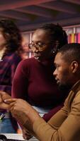 Vertical Teamworking startup engineers brainstorming, working with machine learning tech advancing AI. AI venture business staff members transforming data into predictive models, camera B video