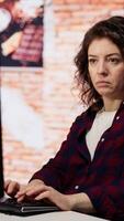 Vertical AI startup company developer testing company software to minimize occurrence of bugs, identifying bottlenecks. Woman in office writing code in programming language to reduce errors video
