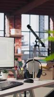 Vertical Empty AI industry startup workplace leveraging machine learning technology. Company office with PC on desk to be used by programmers building scalable solutions for businesses, trucking left shot video