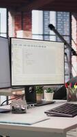 Vertical Empty startup office with PC on desk to be used by programmers building scalable solutions for businesses. AI industry startup workspace leveraging machine learning technology video
