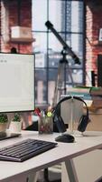 Vertical Advanced AI algorithms running on computer monitors in empty startup workspace deploying machine learning models. Coding platform on PC screens in Silicon Valley office, trucking left shot video