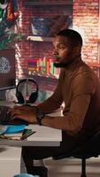 Vertical Startup company back end developer fixing applications issues, dealing with databases and server configuration. Man in office optimizing software for improved performance and scalability, camera A video