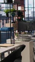 Vertical PC screens in innovative startup office showing programming languages used to build applications. Empty software development agency used for optimizing code on computers, handheld camera shot video