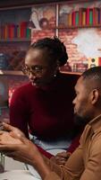 Vertical Teamworking programmers creating deep learning models analyzing data in artificial intelligence development agency. African american IT coworkers programming in AI startup office, camera A video