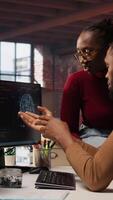 Vertical Team of startup admins doing brainstorming, working with machine learning tech advancing AI. Software development agency staff members transforming data into predictive models, camera A video